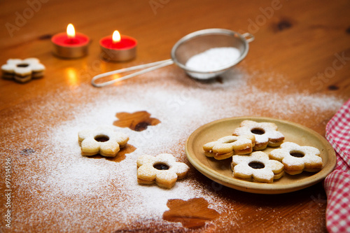 christmas cookies with fruit jelly on wooden table