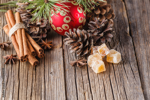 christmas ball on rustic table with spices