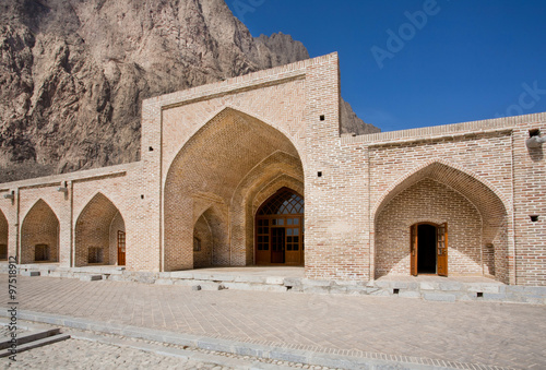 Gate of the historical stone caravanserai in mountains of Middle East