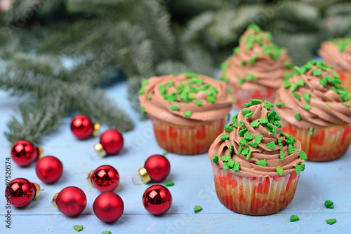 cupcakes with chocolate cream on a blue wooden background with r