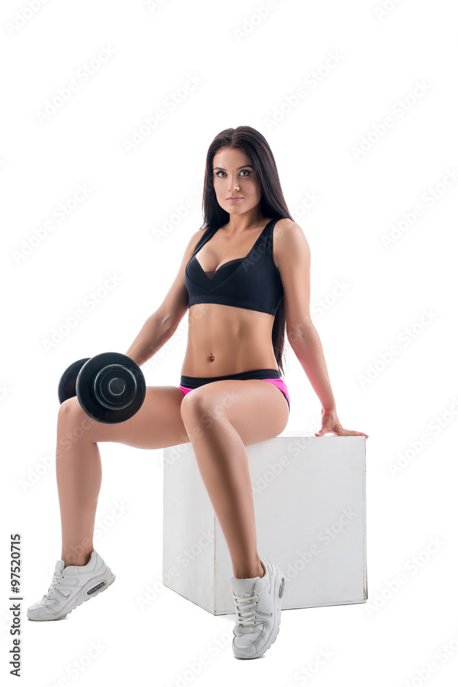 Sexy woman posing while exercising with dumbbells Sexy woman posing while exercising with dumbbells