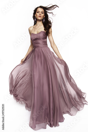 Brunette model in violet dress posing 