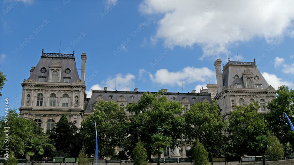 An old gothic style building on the roadside of Paris. Where green trees are found on the front of the building An old gothic style building on the roadside of Paris. Where green trees are found on the front of the building