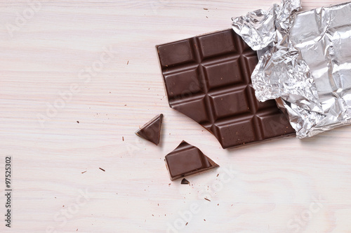 Detail of chocolate bar with silver wrapping top view photo