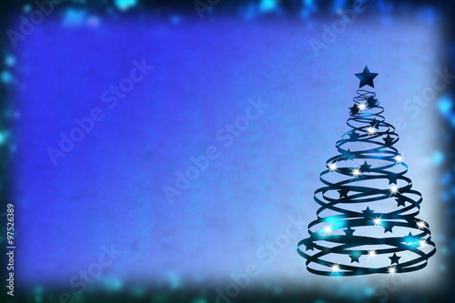 Wonderful Christmas blue  background with shining spiral shaped fir tree photo