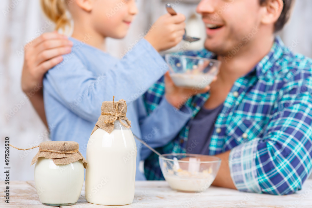 Positive father and daughter having breakfast Positive father and daughter having breakfast