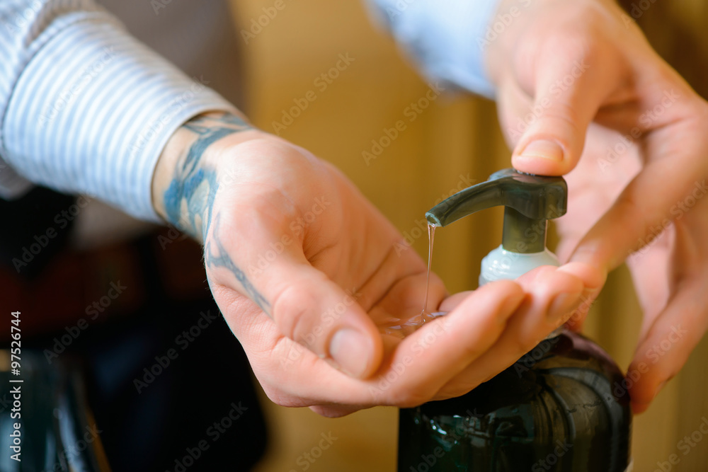 Obraz premium Professional barber washing hair of the client