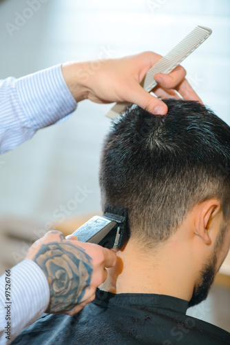 Professional barber making haircut 