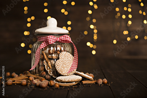 Gingerbread cookies in a jar on a wooden background