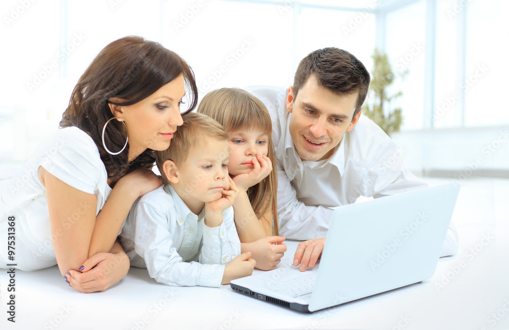 family looking into the laptop enthusiastically