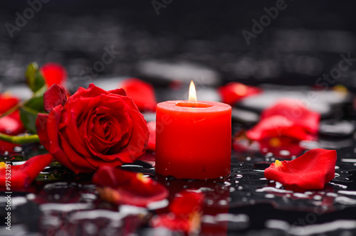Beautiful rose petals with candle and therapy stones ,