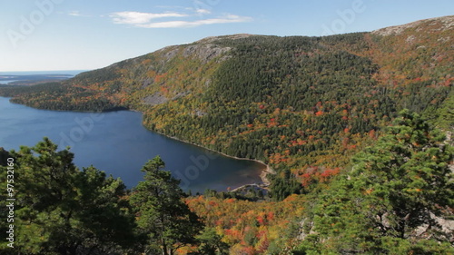 Aerial, panning view of Jordan Pond, Acadia National Park, in Autumn, looking east towards the Atlantic Ocean and the Cranberry Isles. Penobscot Mountain is in the mid-foreground on the right. photo