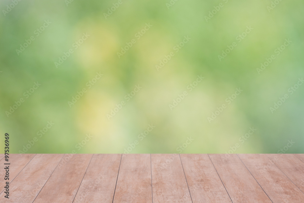 Wood table top on bokeh abstract green background - can be used for montage or display your products