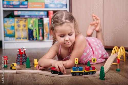 Girl play with a toy train