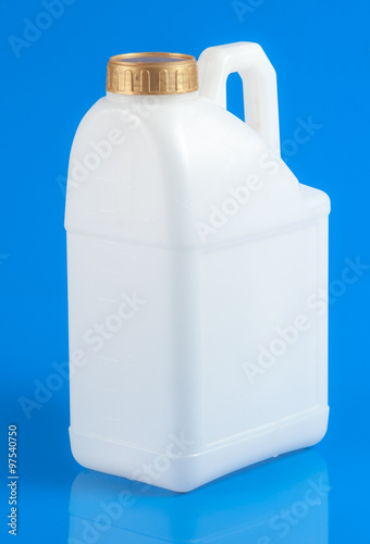 White plastic container with yellow cap on blue background