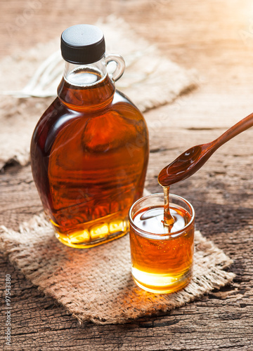 Slika na platnu maple syrup in glass bottle on wooden table