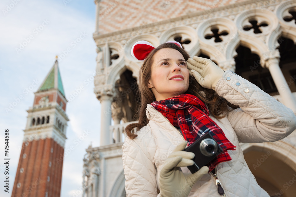 Fototapeta premium Happy woman tourist with camera on Christmas in Venice, Italy