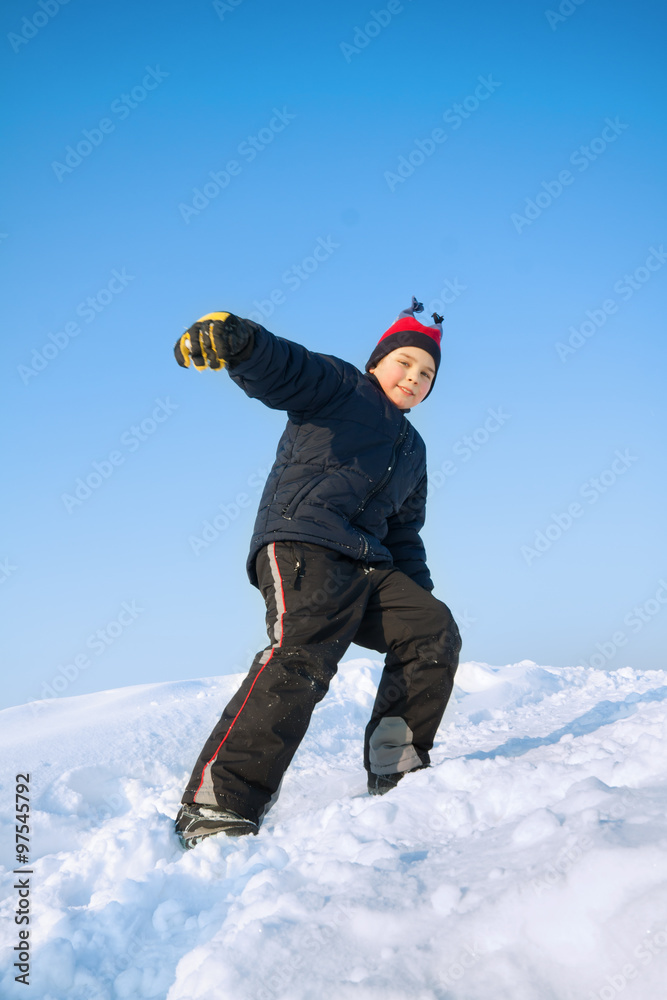 Little child playing in snow