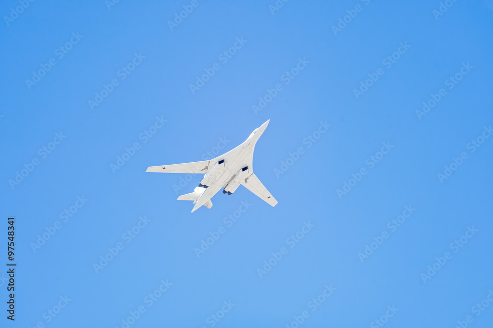 Tupolev Tu-160M (Blackjack) supersonic, variable-sweep wing heavy strategic bomber flies against blue sky background Tupolev Tu-160M (Blackjack) supersonic, variable-sweep wing heavy strategic bomber flies against blue sky background