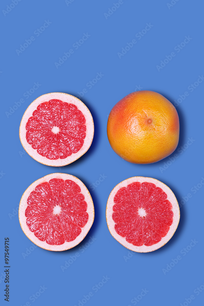 Fotografie Minimal Design. Fresh Grapefruit on a blue background