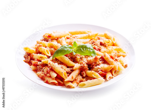 plate of penne pasta bolognese on white background
