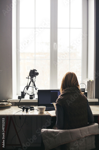 Workplace with open laptop with black screen  on modern wooden desk, angled notebook on table in home interior, filtered image.
Photographer, camera