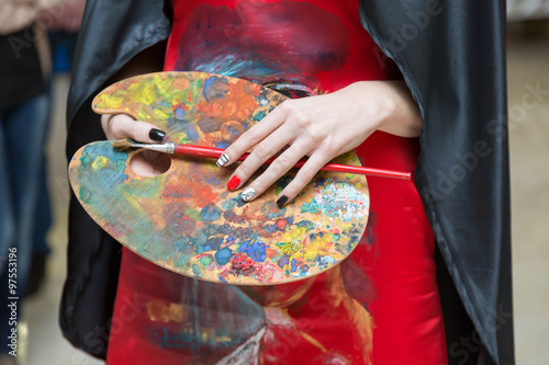 palette for paints in woman hands