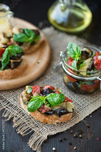 Toast with baked eggplant with tomatoes, garlic