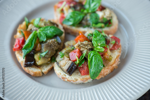 Toast with baked eggplant with tomatoes, garlic