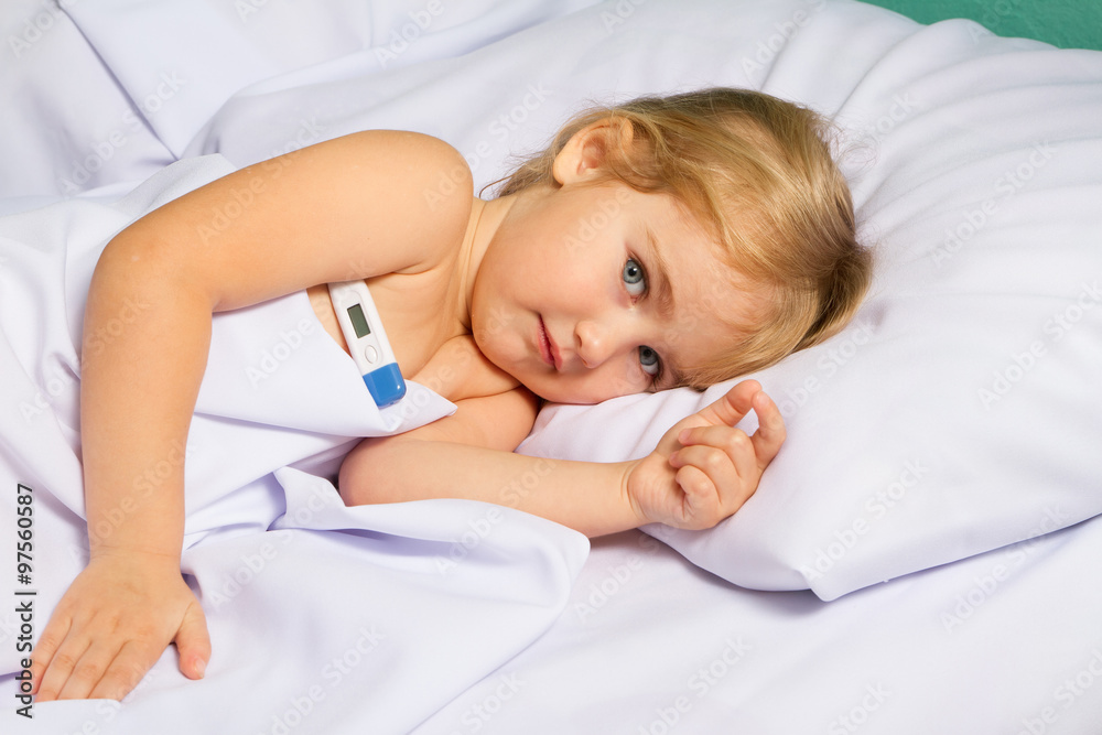 Sick little girl in bed.
