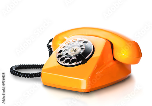 Vintage orange telephone on white photo