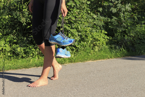 A woman goes barefoot after jogging
