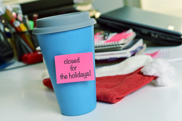 text closed for the holidays in a mug