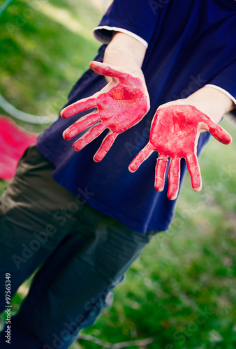 Man with hands painted with red body paint