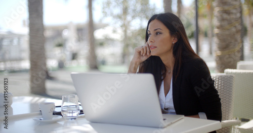 Businesswoman sitting thinking at a restaurant