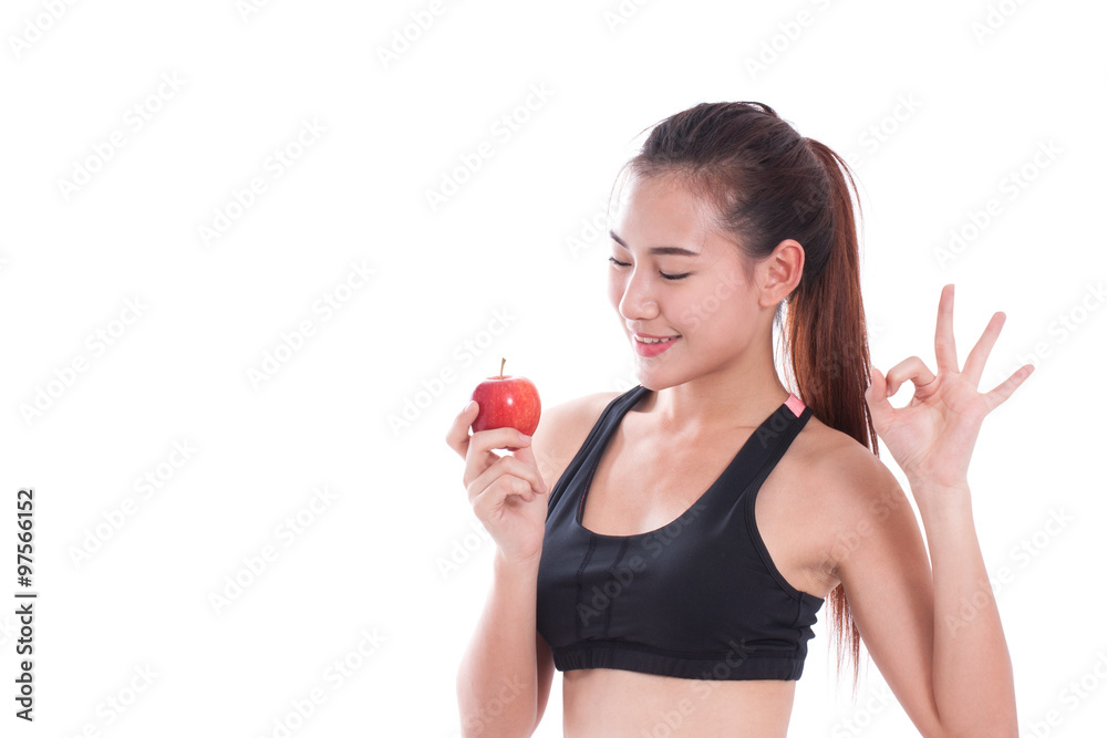 Fitness woman holding apple and showing ok sign on white background. healty concept Fitness woman holding apple and showing ok sign on white background. healty concept