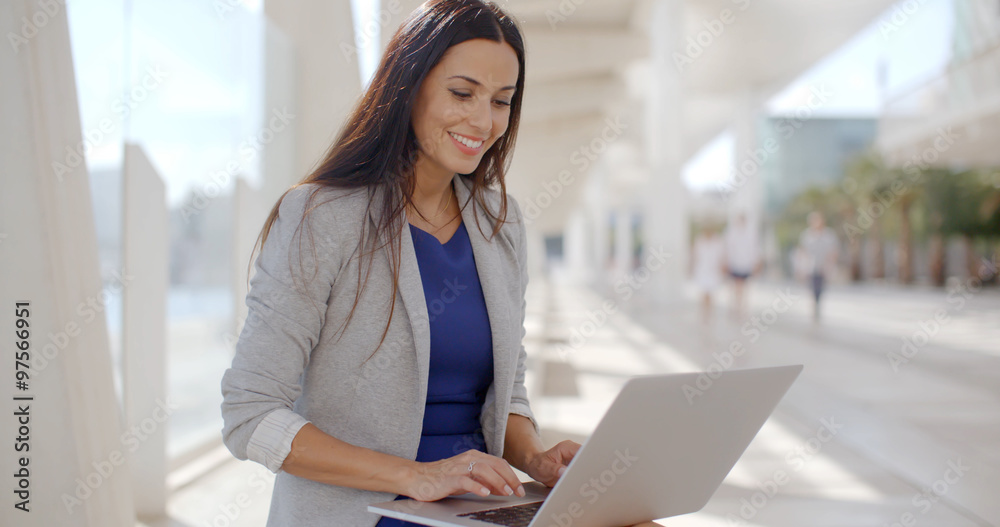 Businesswoman relaxing and working on a laptop Businesswoman relaxing and working on a laptop