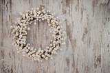 white christmas decorative wreath over wooden background