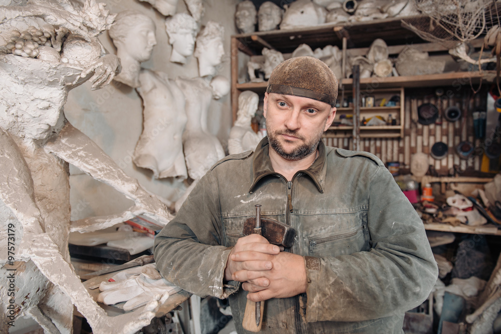 Portrait of sculpture man in his workshop
