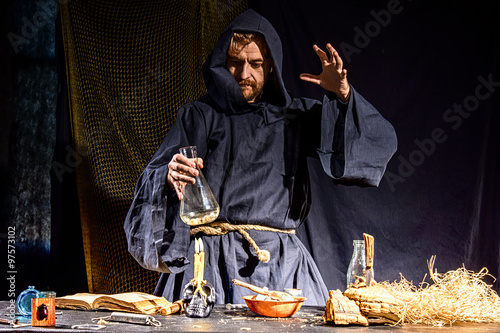 Portrait of a crazy medieval scientist working in his laboratory