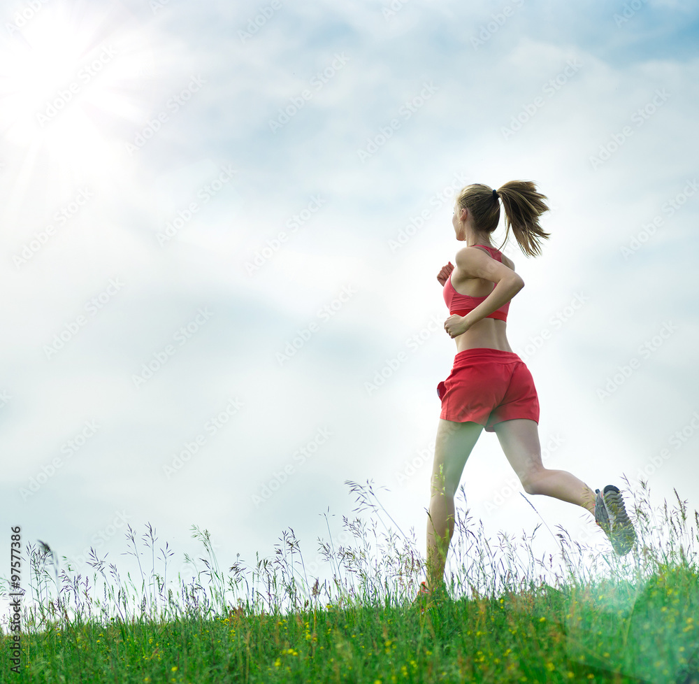 Young woman running summer park rural road. Outdoor exercises. J Young woman running summer park rural road. Outdoor exercises. J