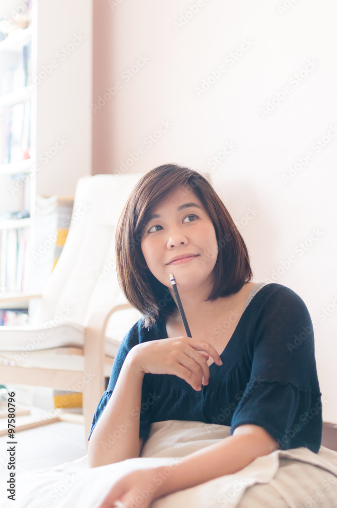 Young asian woman writing. Young asian woman writing.