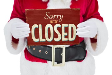 Composite image of mid section of santa claus holding page