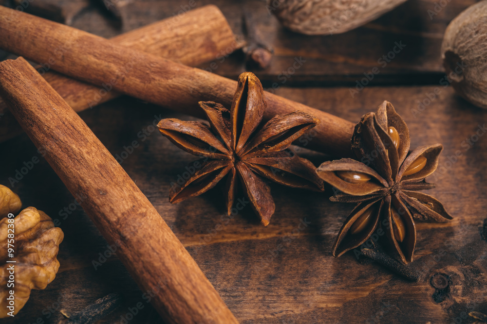 Collection of spices for mulled wine and pastry on the wooden table Collection of spices for mulled wine and pastry on the wooden table