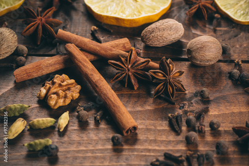 Fototapeta Naklejka Na Ścianę i Meble -  Collection of spices for mulled wine and pastry on the wooden table