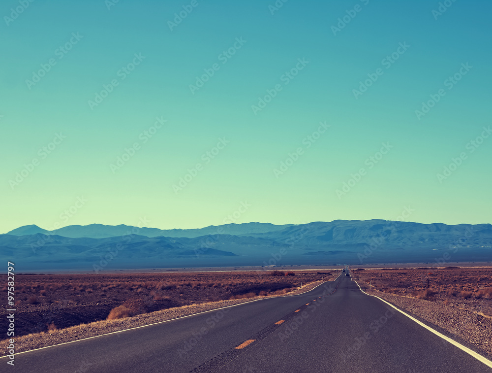 Straight lonely highway in a sunny day