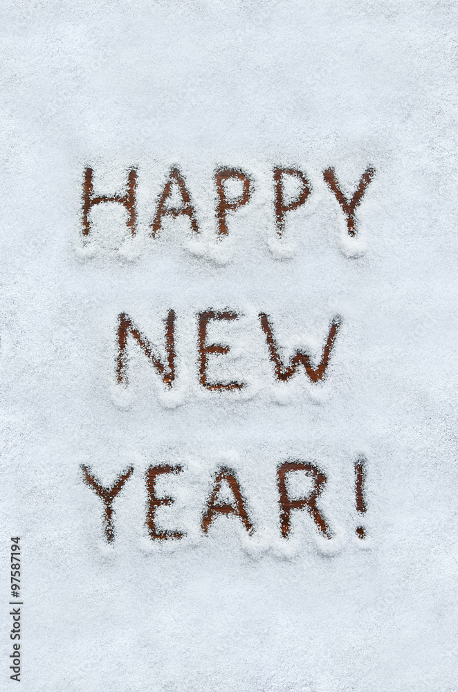 Text HAPPY NEW YEAR written on snow with wood background. Vertical holiday top view postcard. Text HAPPY NEW YEAR written on snow with wood background. Vertical holiday top view postcard.