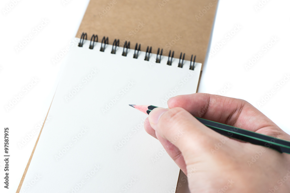 white sketch book and pencil with man hand on white white sketch book and pencil with man hand on white