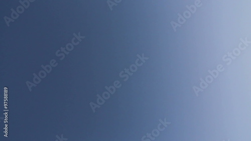 HD footage of a twin engine jet plane passing overhead diagonally photo
