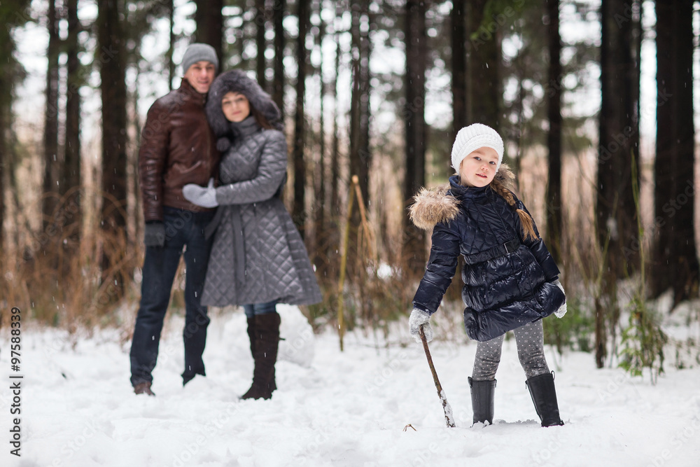 Happy family walking in a winter park.